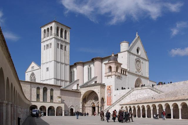 The Basilica of St Francis in Assisi on its hillside, seen from the plain below