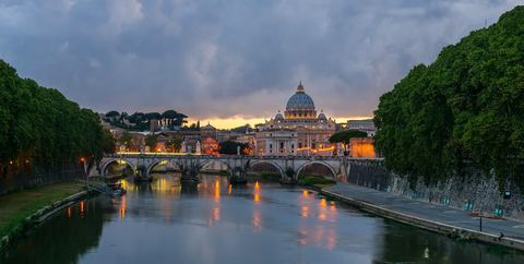 The Tiber at dusk from Ponte Sant'Angelo: the night walks and the Vespa tours cross here after the Colosseum